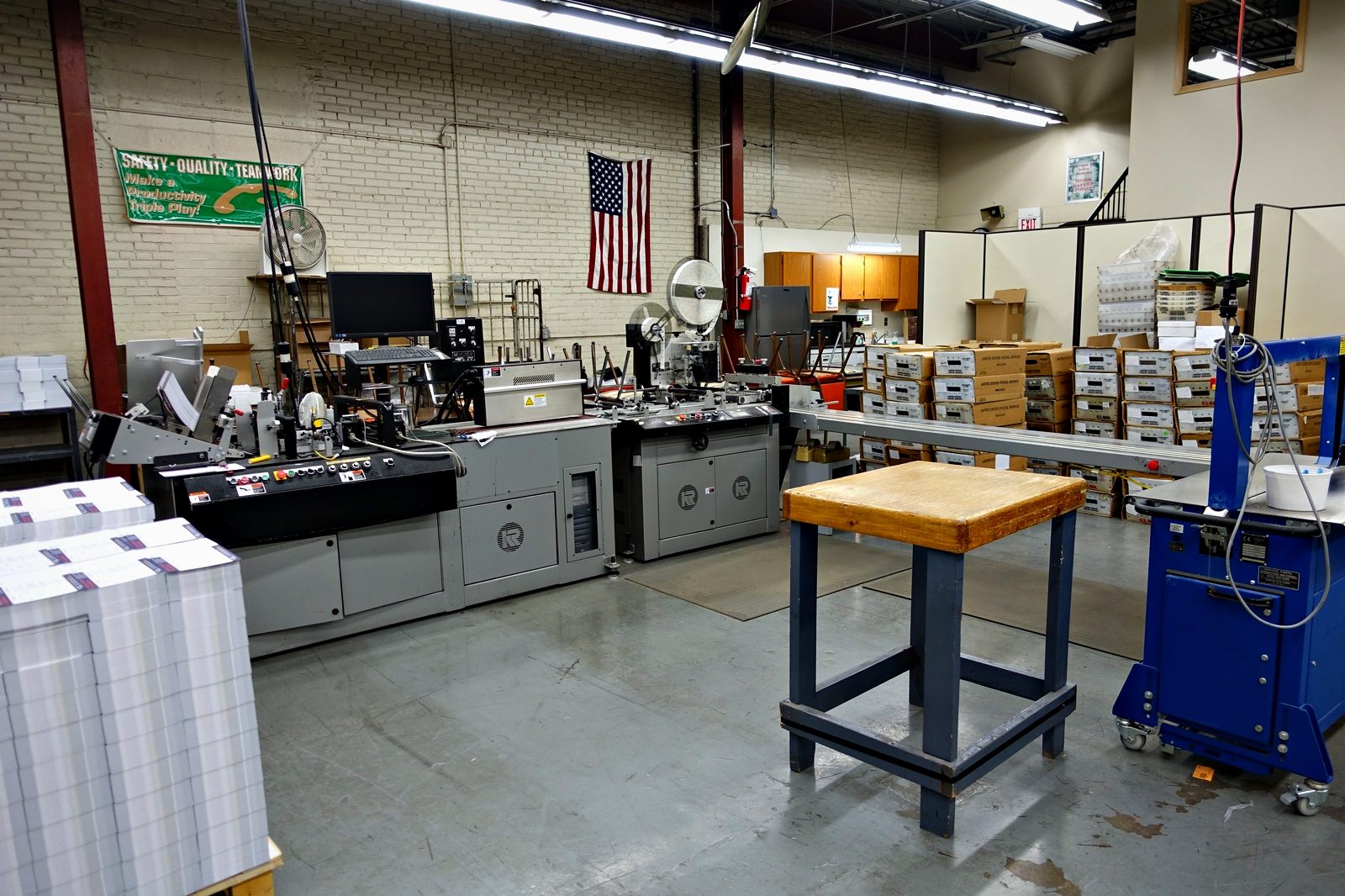 The mailing department at Broudy Printing, with work stacked and boxed alongside the line