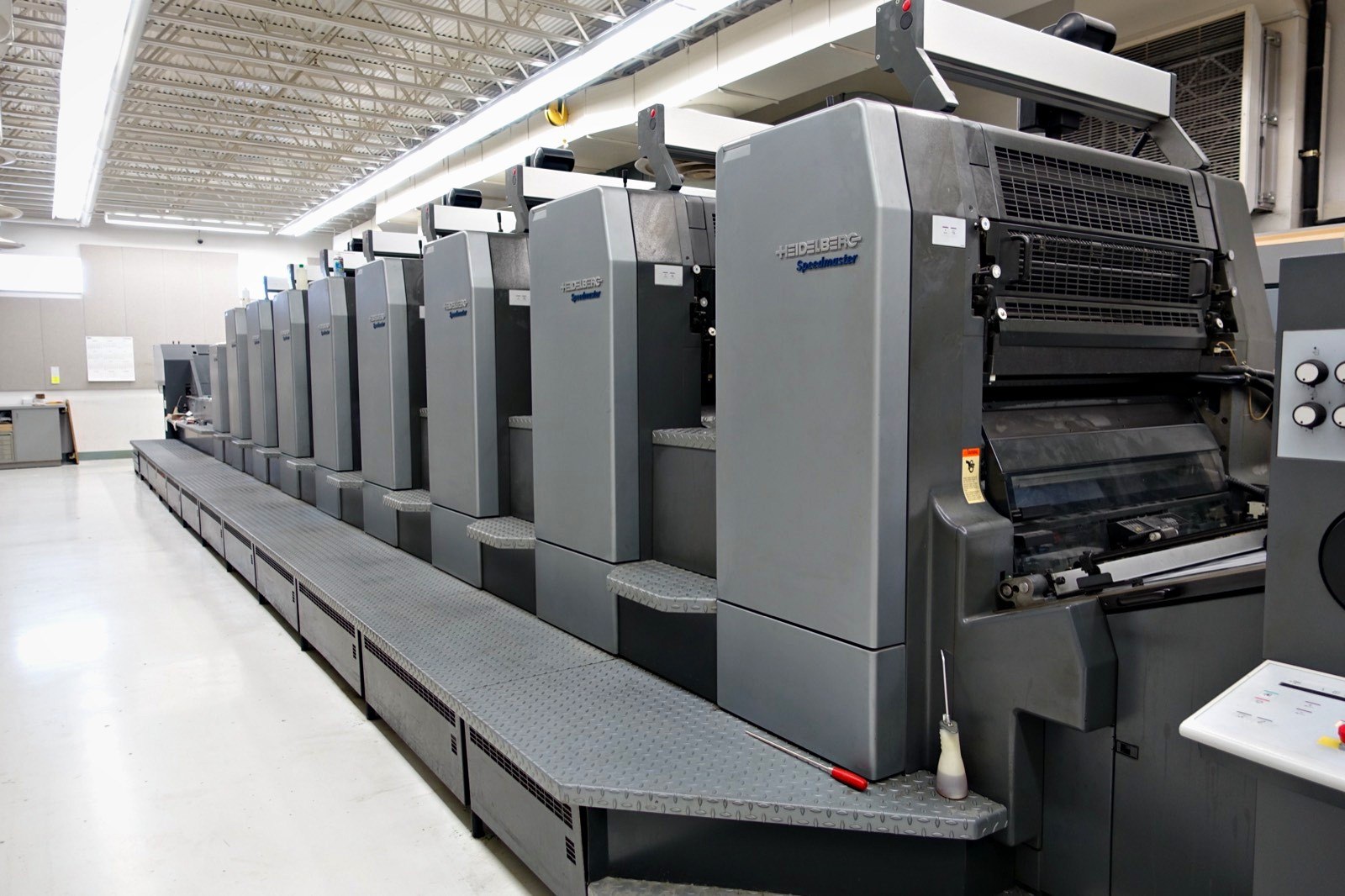 The eight-color Heidelberg Speedmaster CD 102 with coating tower on the pressroom floor at Broudy Printing